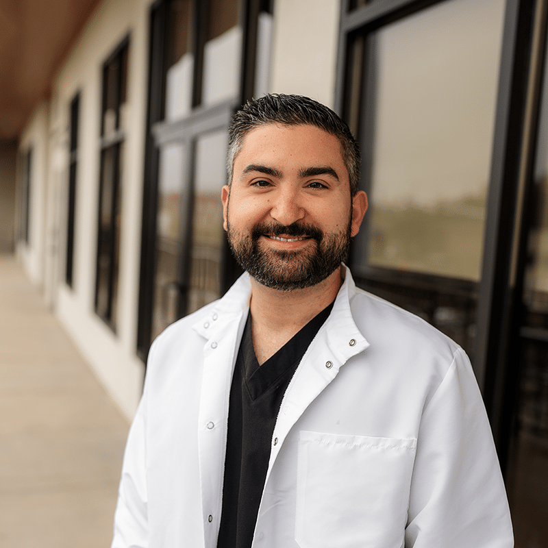 Dr. Minavi_White Coat_square Dr. Brian Minavi headshot